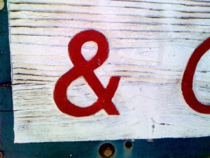 a wooden sign ampersand